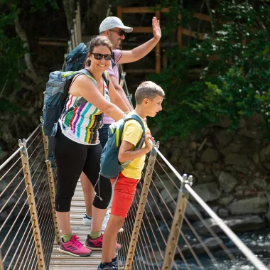 Crossing the footbridge in the Clues de Barles with the family