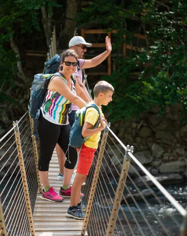 Crossing the footbridge in the Clues de Barles with the family