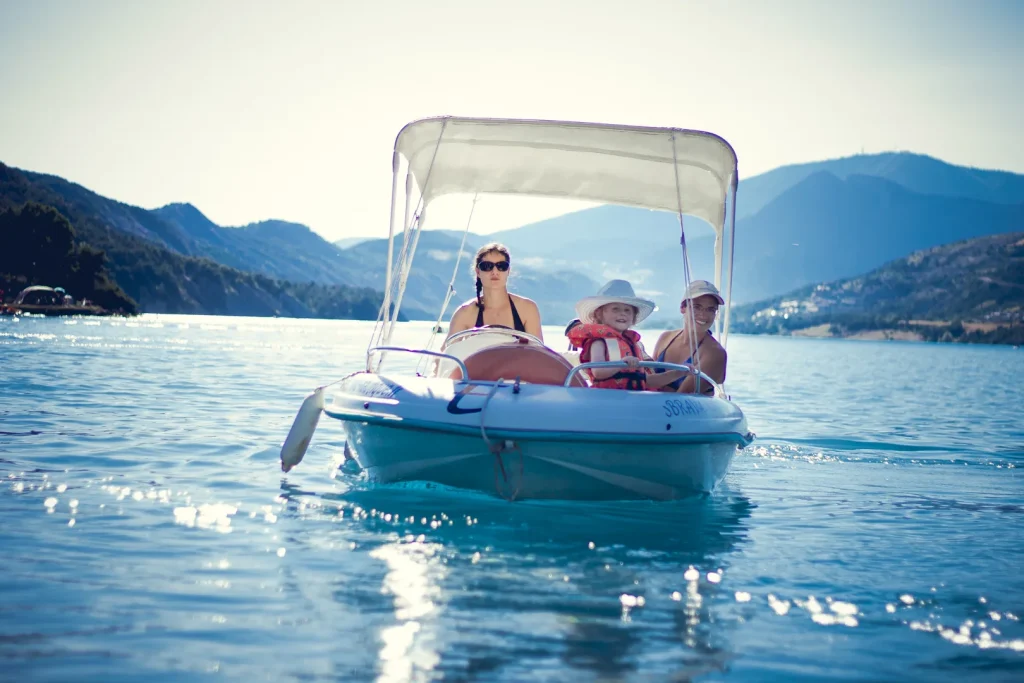 Famille dans un bateau électrique sur le lac de Serre-Ponçon.